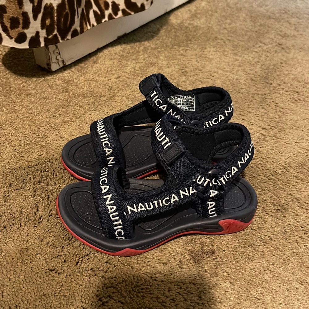 Nautical sandals that are blue with white on them. Brand new children’s sandals